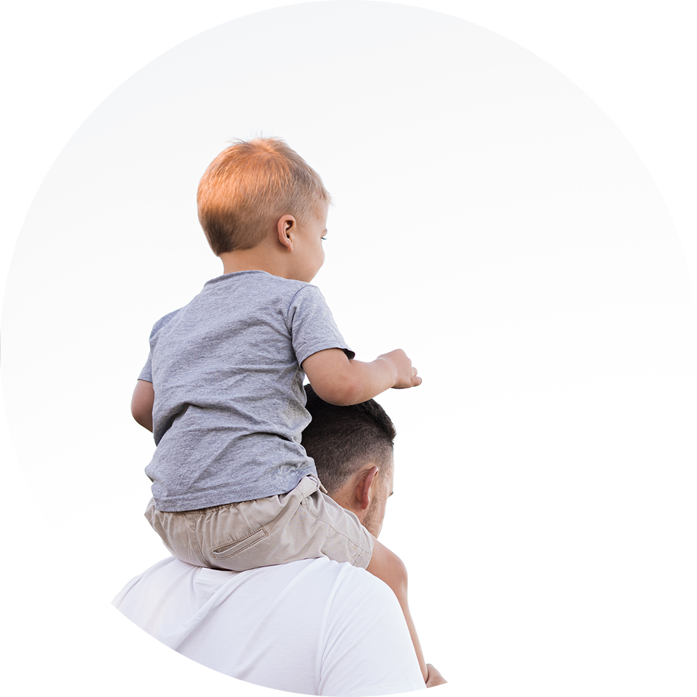 Child playfully sitting on father's shoulders